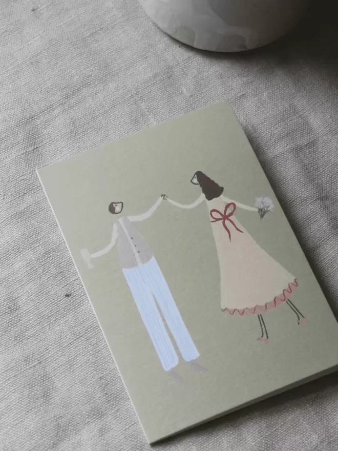 a cute couple dancing illustration on a greetings card