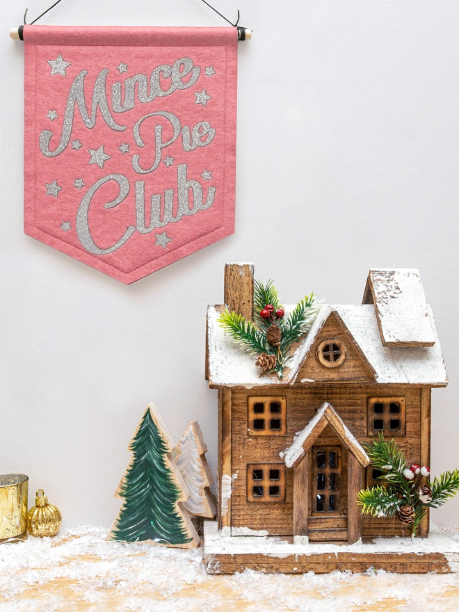 Christmas "Mince Pie Club" banner in rose pink felt with silver glitter text. the text is surrounded by glittery stars.. 