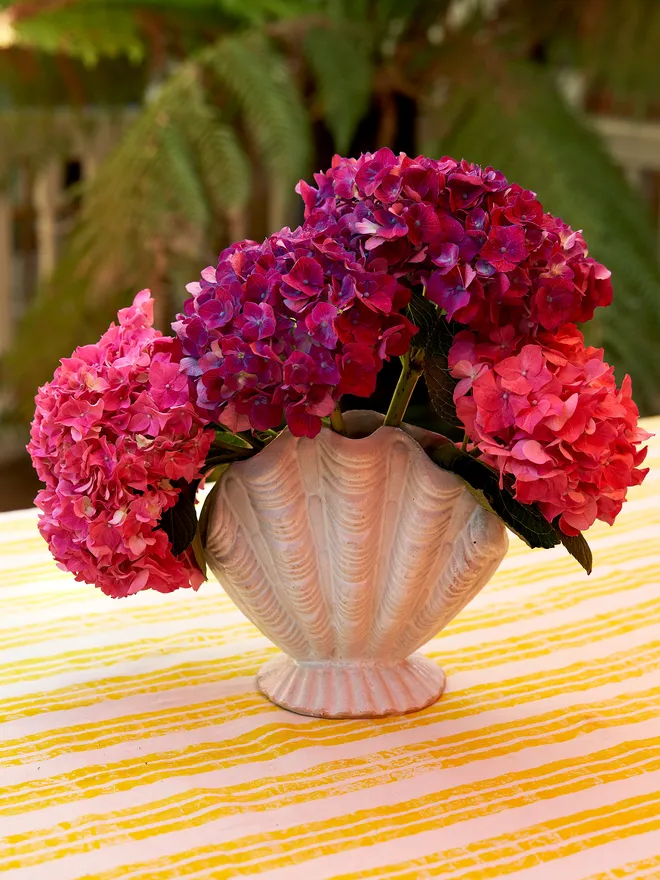 Ceramic Scallop Shell Vase on a yellow and white tablecloth