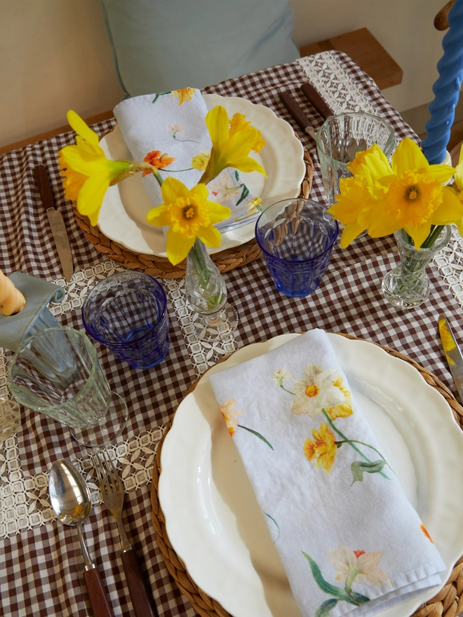 Table laid with linens printed with daffodils
