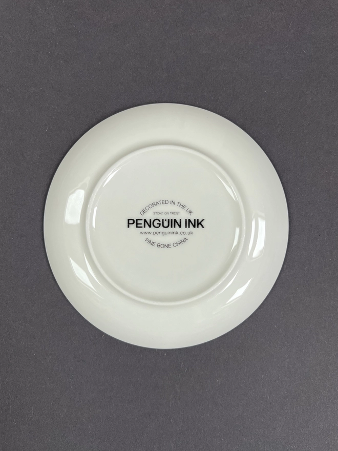 Bottom of the round trinket tray showing the Penguin Ink logo decal