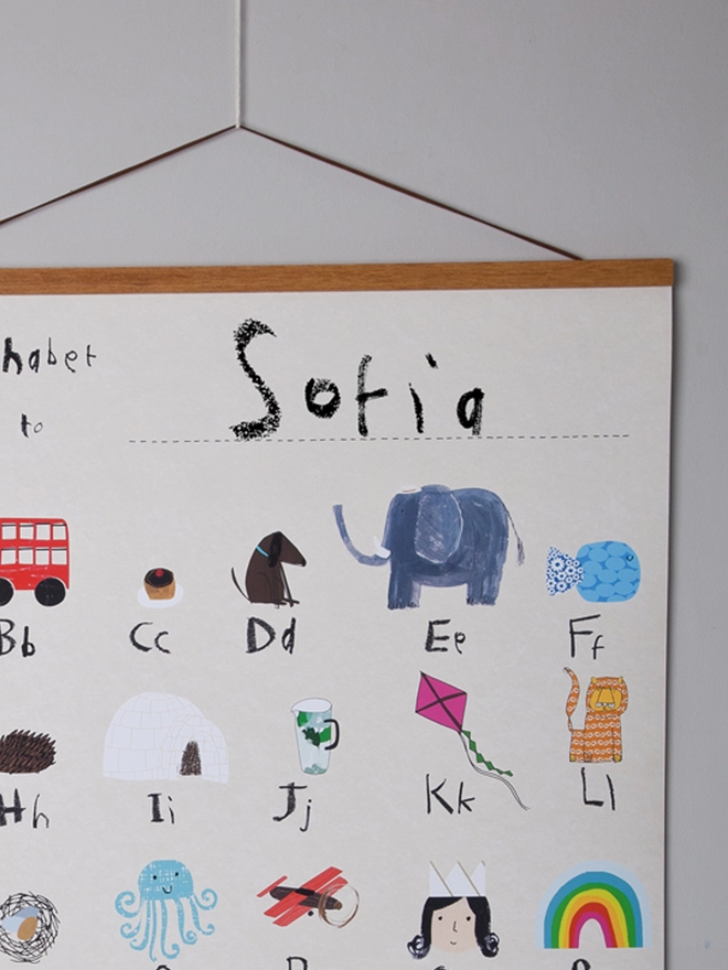 detail of alphabet poster with oak poster hanger, e is for elephant, l for lion
