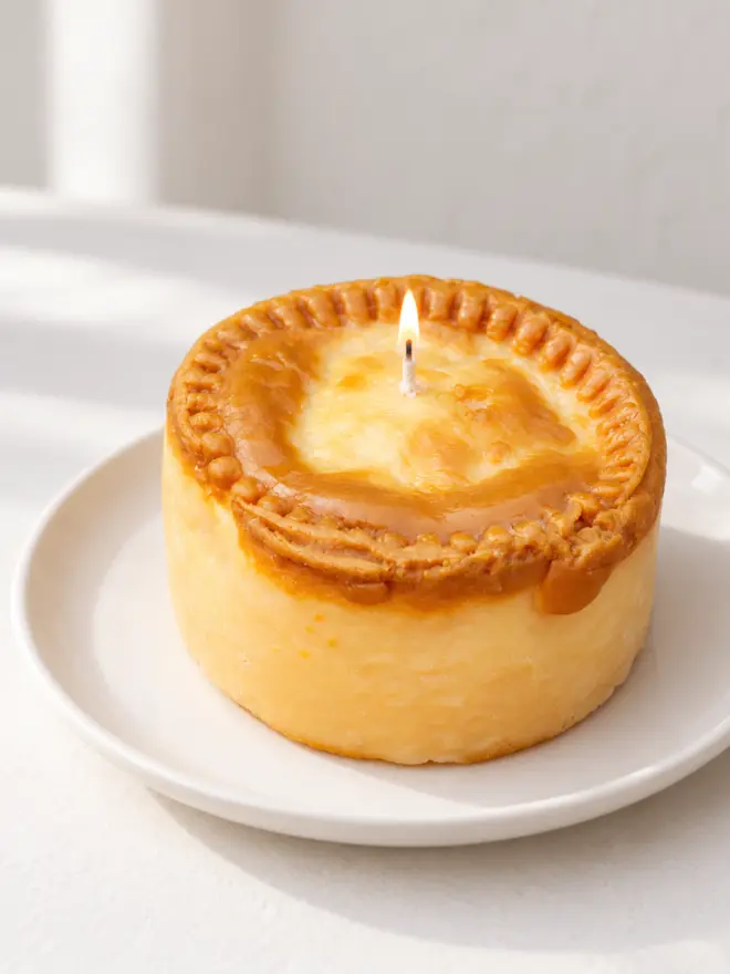 pork pie candle on a white plate