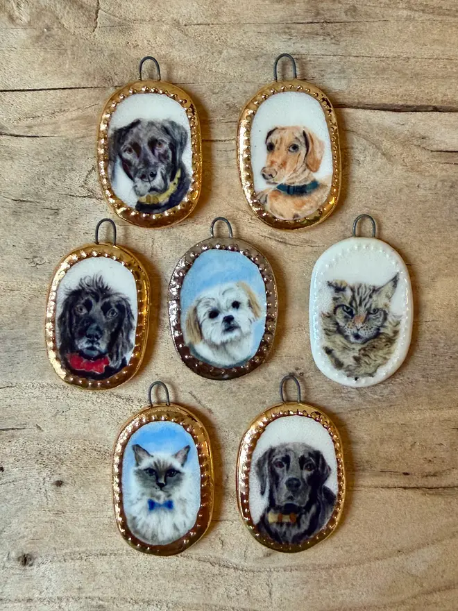 custom pet portrait pendant miniatures. a dog portrait in a pendant frame, next to a 1p coin for scale.