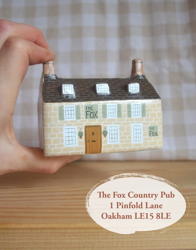 handmade ceramic sculpture in design of a pub