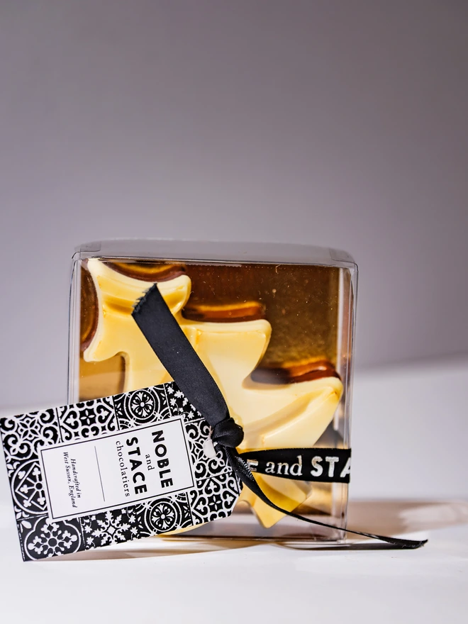 A clear box containing 3 solid chocolate Christmas Trees, one each in Milk, White and Dark chocolates