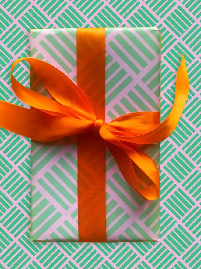 Geometric Criss Cross Pattern Wrapping Paper, against a pattern background. 