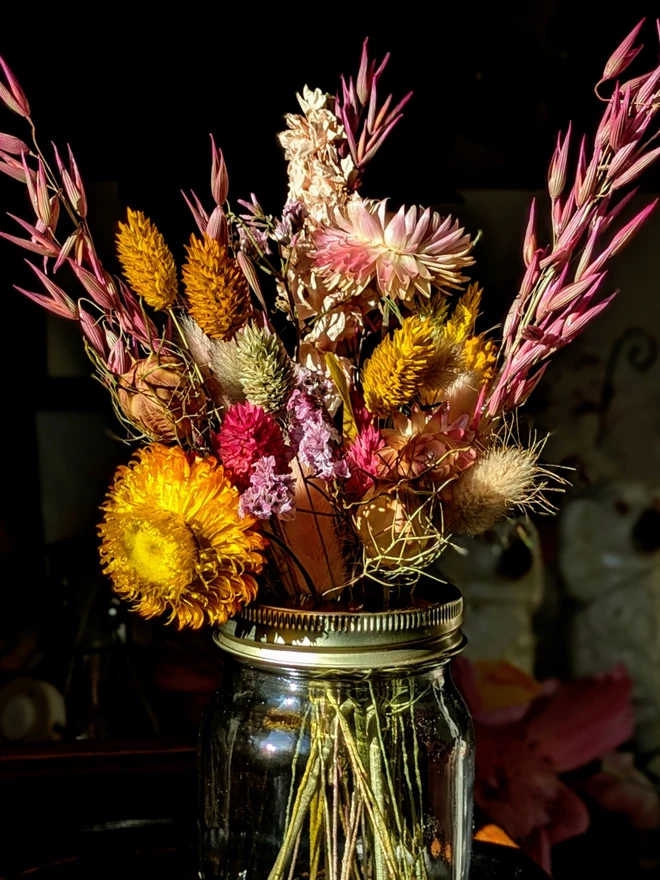 Dried flowers in mason jar with daisy lid