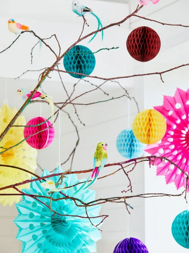 Paper decorations hanging from branches.