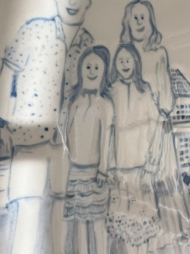 personalised family portrait round platter. a close up of an illustrated family portrait on a plate.