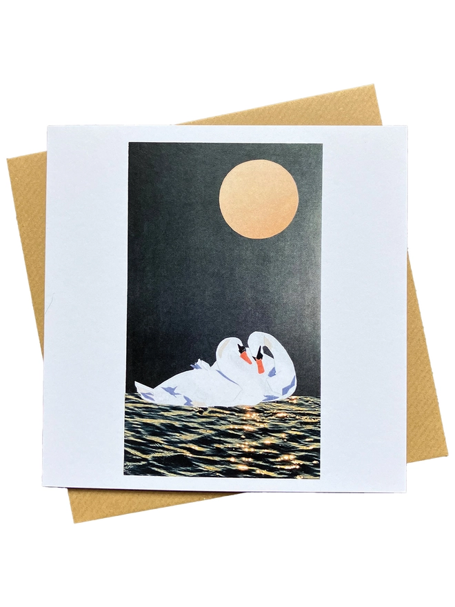 Greetings Card of a recycled paper collage of two romantic swans under the moon