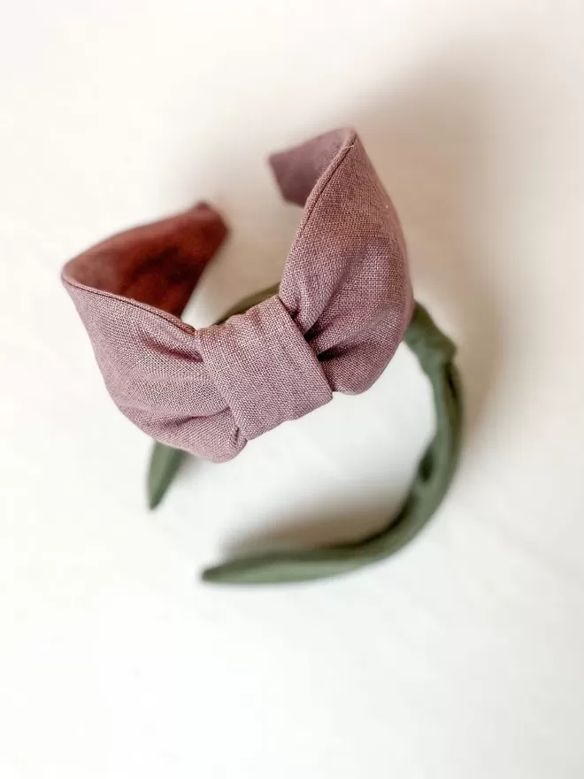 Vanessa Rose Ines Hairband in Lilac Pink seen from above with a green headband.