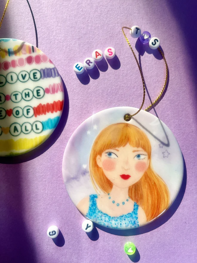 Taylor Swift christmas tree decoration featuring portrait of the singer and lyric quote