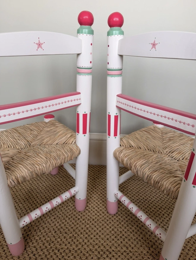 Hand-painted Childs chair with pink and green details. 
