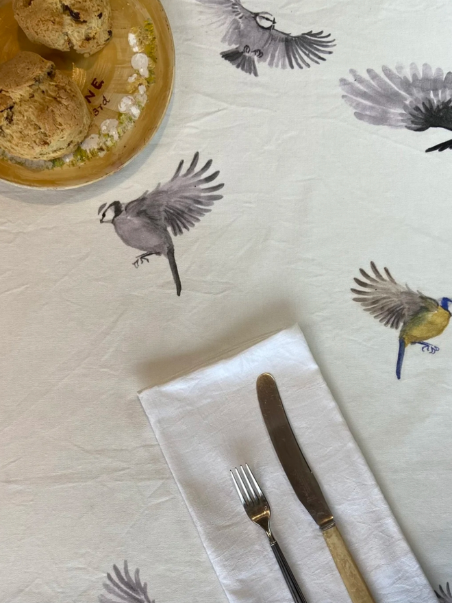 Bird Tablecloth. A white tablecloth patterned with birds.