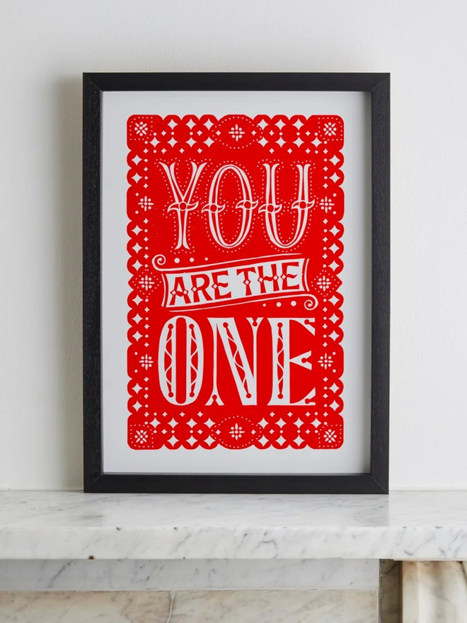 you are the one linocut. a linocut phrase printed on red paint.