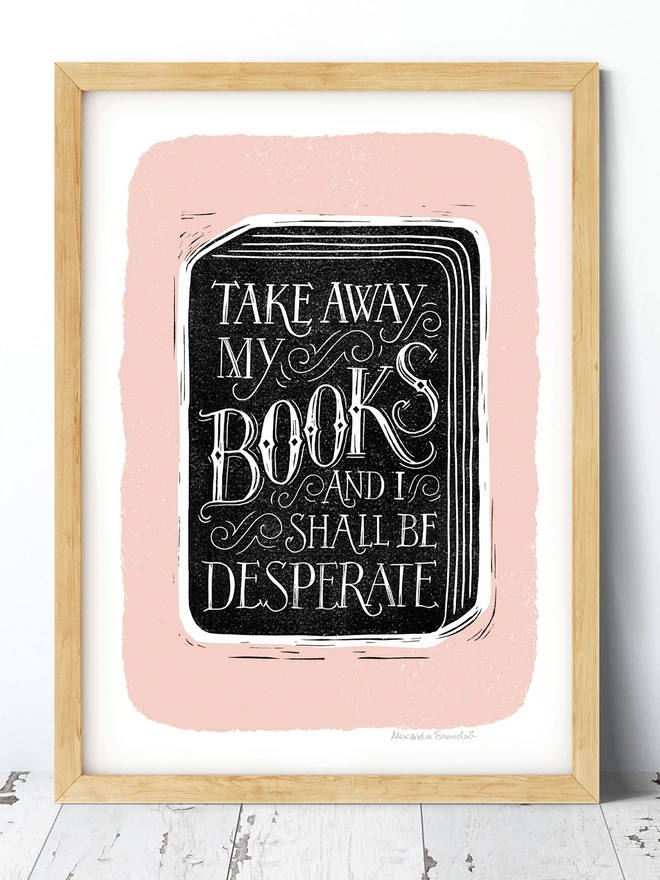 hand carved reading books quote print in black and white with pink background in a wood frame