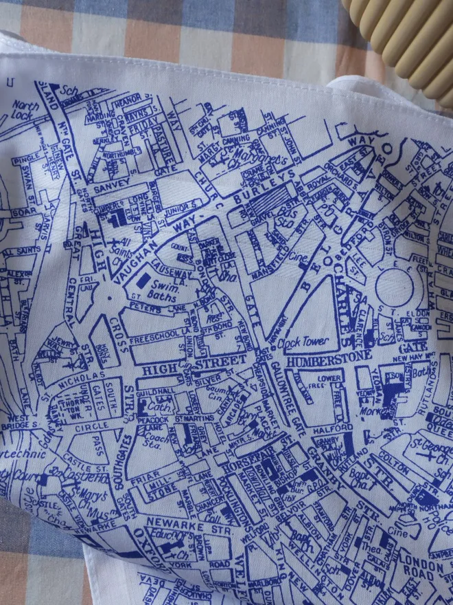 Mr.PS Leicester map handkerchief, printed in blue, on a gingham tablecloth