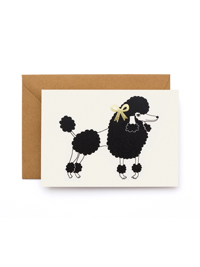Greeting card featuring a poodle dog wearing a gold bow 