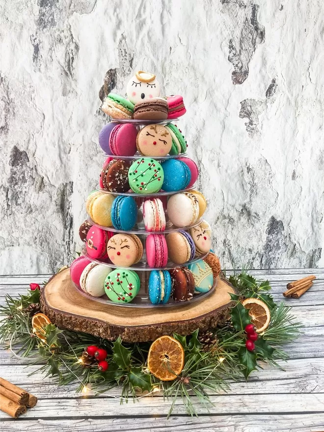 a christmas tree tower made out of colourful macarons