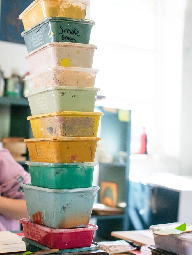 A stack of paint tubs stacked in a tower