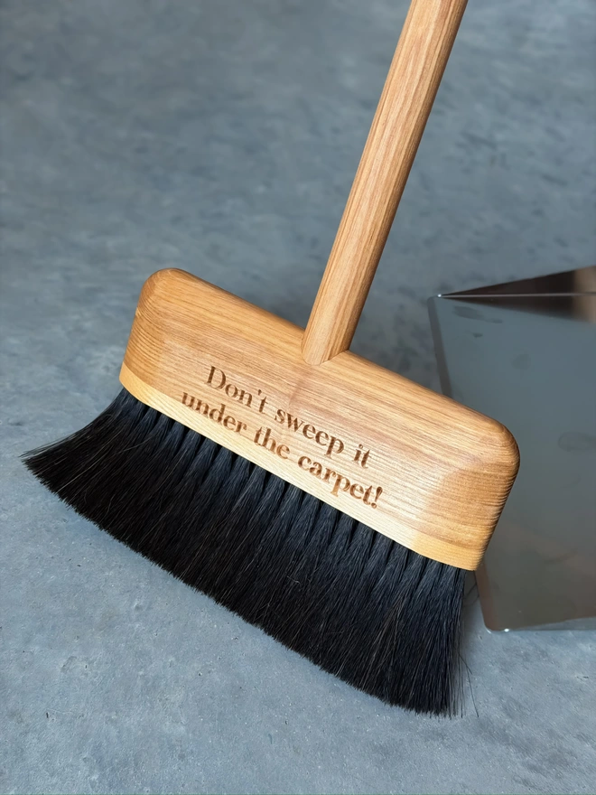Close-up of the broom head engraved with a personalised message