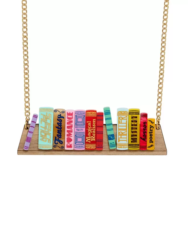 A Tatty Devine World book day bookshelf necklace showing colourful books sitting on a wooden shelf.