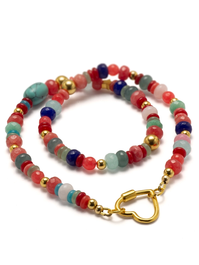 The Love Drunk Necklace is a bold, joyful mix of coral red jade and cooling aqua agate beads, interspersed with warm gold plated accents. Fastened with a statement heart-shaped carabiner, it’s playful, vibrant, and full of feeling — a colourful celebration of love, confidence, and carefree sunny energy.