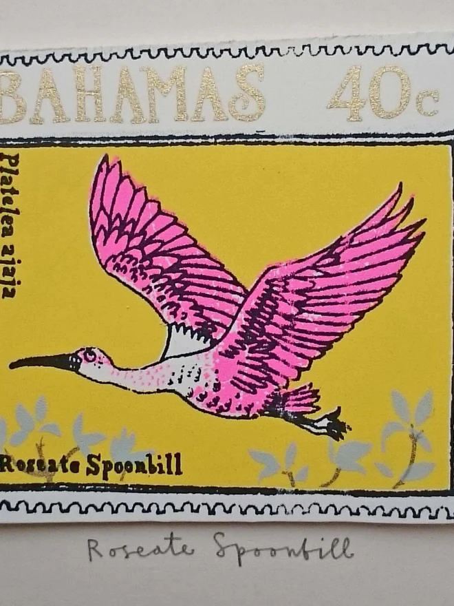 Bird Stamp Card Roseate Spoonbill/ Bahamas, a white card with a colourful bird design in the centre on top of a white surface. 