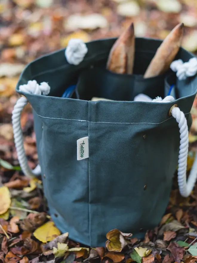 'the henley' canvas picnic bag. a canvas bag photographed open to show picnicware inside.