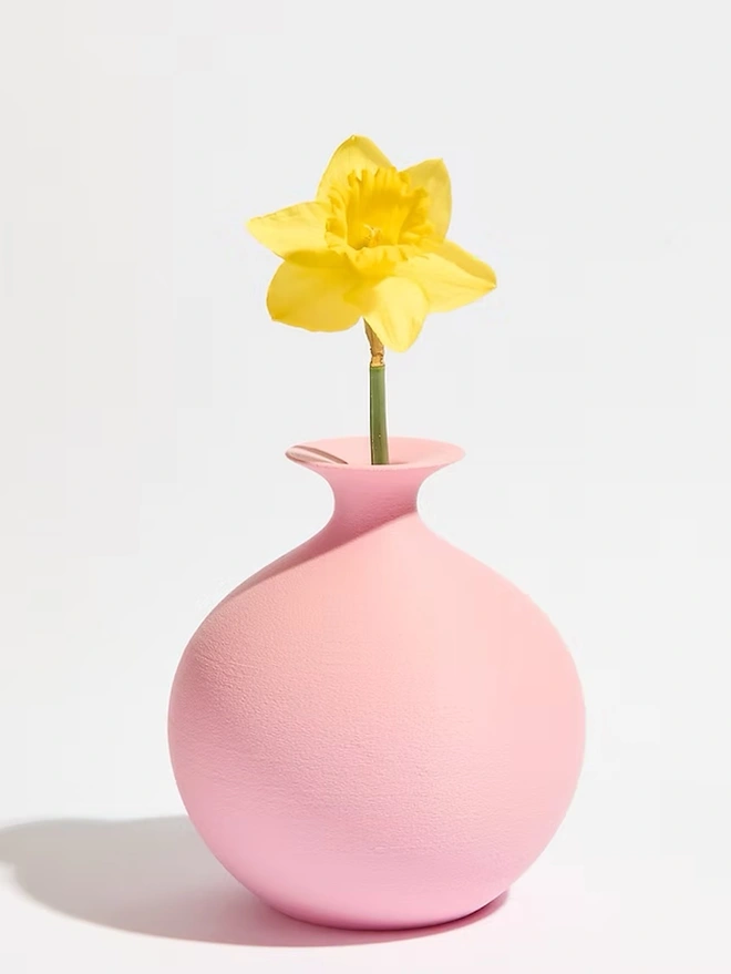 pink 3d printed vase in sphere shape with yellow flower