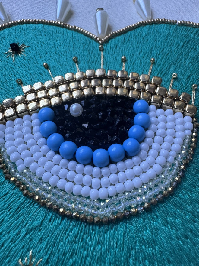 An embroidered heart containing a protective beaded eye