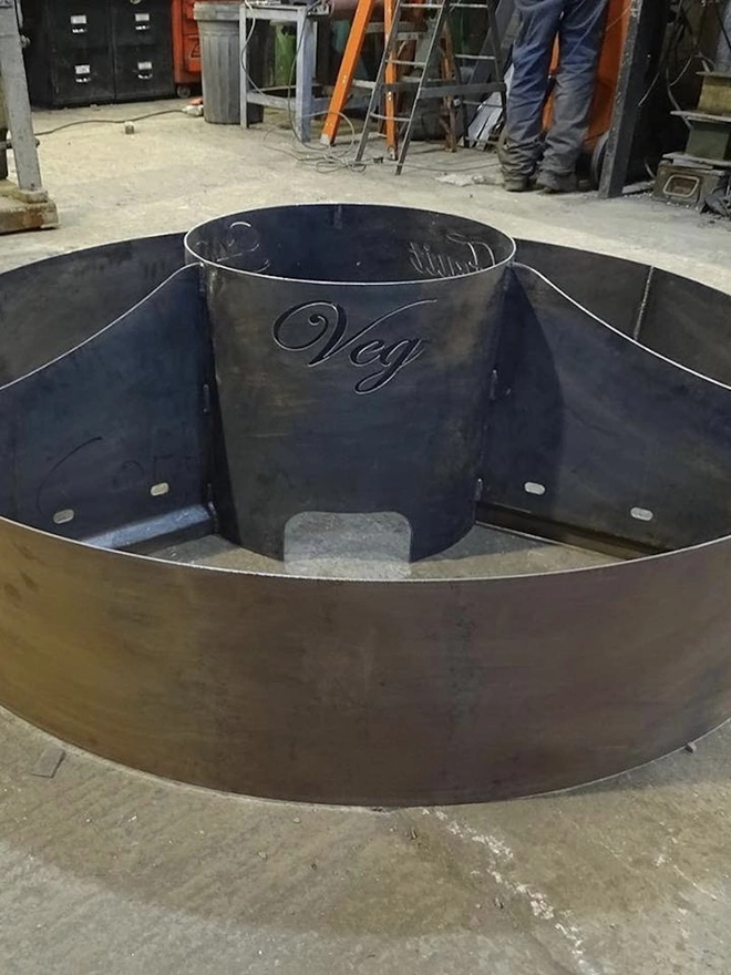 Circle Of Life Corten Vegetable Planter, in room with inscription on it. 