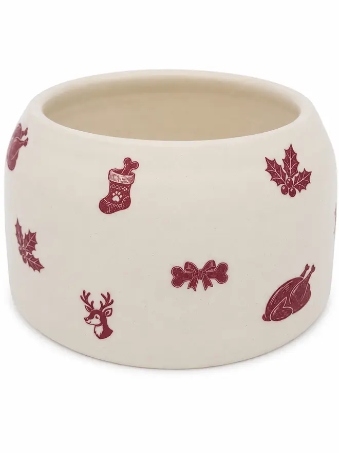 Reverse of a handmade Christmas Cocker Spaniel bowl decorated with burgundy turkey, holly, stocking, bone and reindeer motifs.