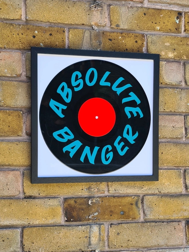 'Absolute Banger' 12" As Seen On TV Vinyl Artwork, a colourful vinyl sitting on a brick wall