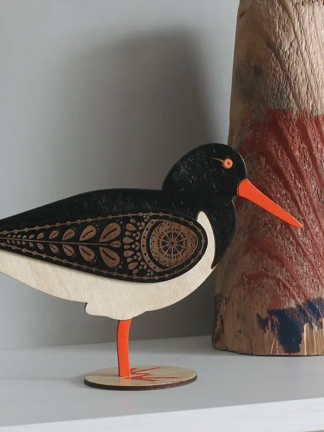 Standing Wooden Oyster Catcher, wooden bird decoration standing on a platform. 