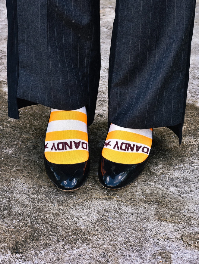 Orange neon breton stripe socks showing Dandy star logo