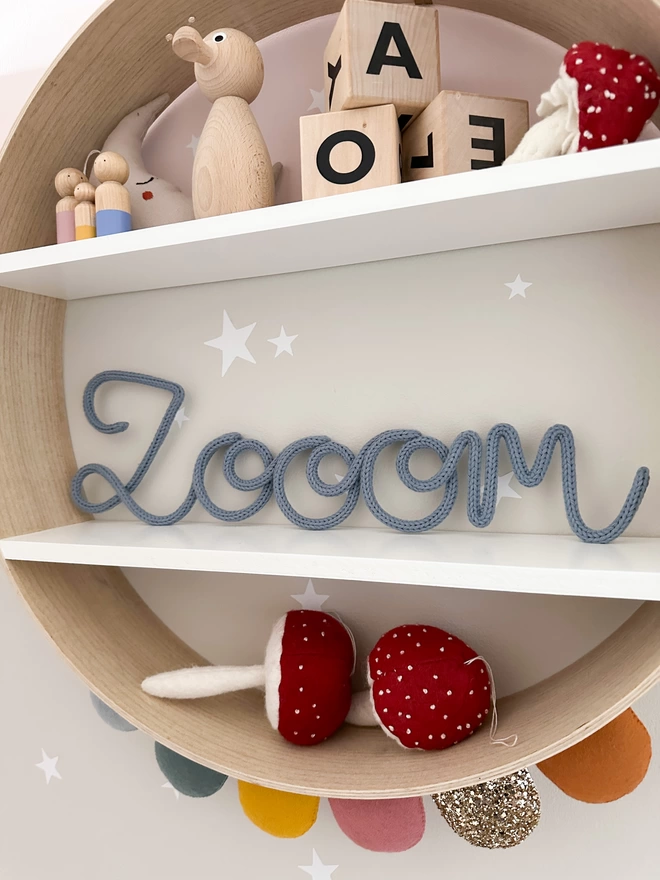 "Zooom" knitted wire sign in a space theme kids bedroom. 