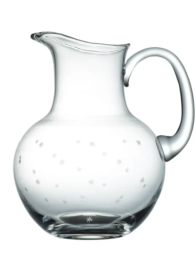 engraved stars crystal water jug. a glass jug patterned with small stars.