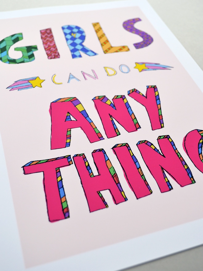 Close up of an art print saying 'Girls can do anything'