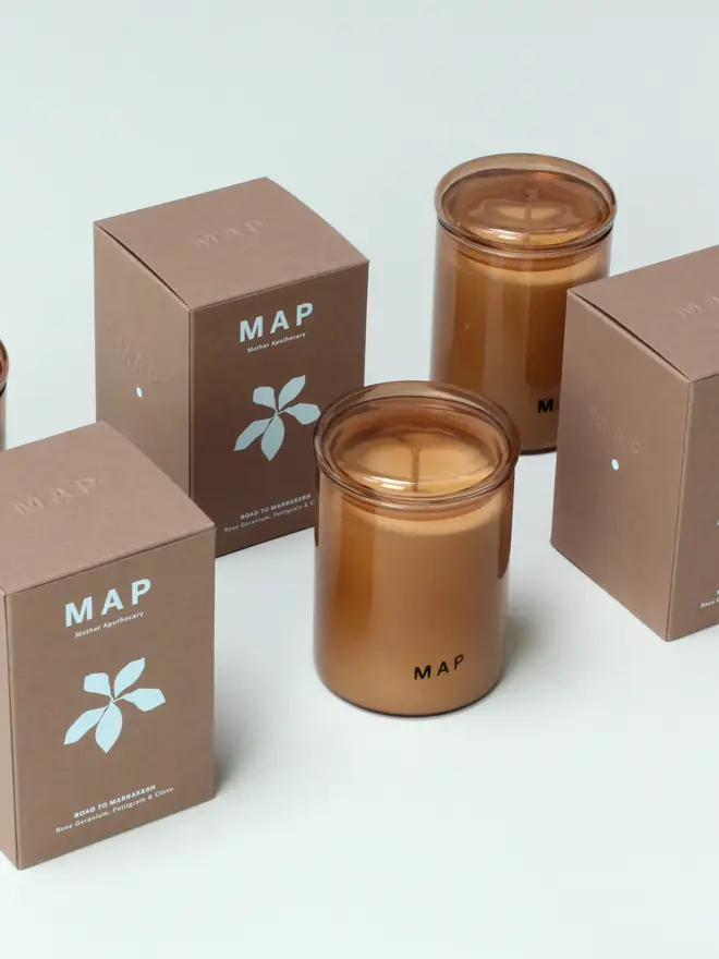 road to marrakesh rose and petitgrain soy candle. candle photographed with plastic free box packaging.