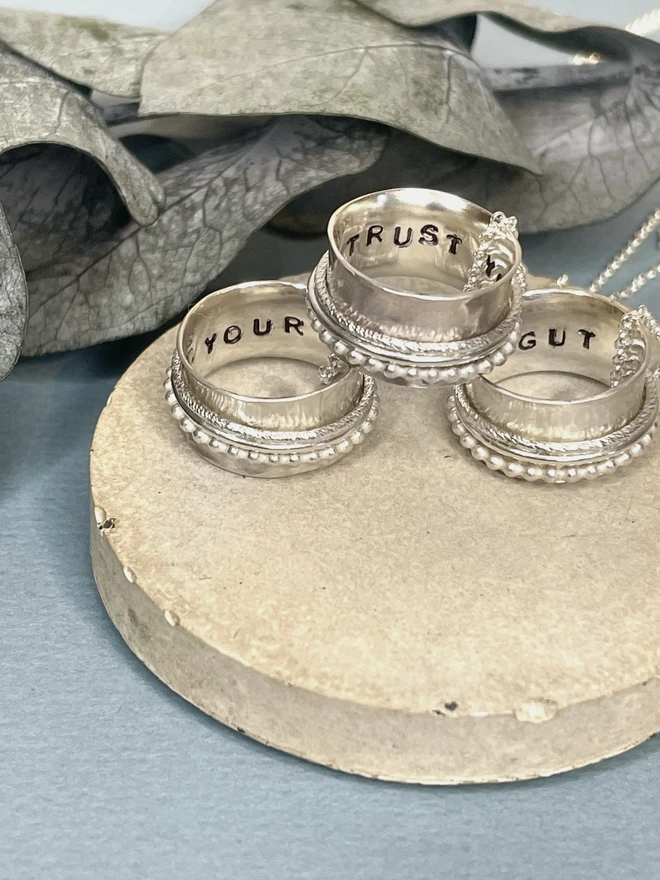 The 'Trust Your Gut' Spinner Pendant Necklace, gives you the reminder you need when the going gets tough. An adult fidget spinner to give you something tactile to do with your hands. This piece of jewellery is hand made from recycled sterling silver from a small business in the UK.