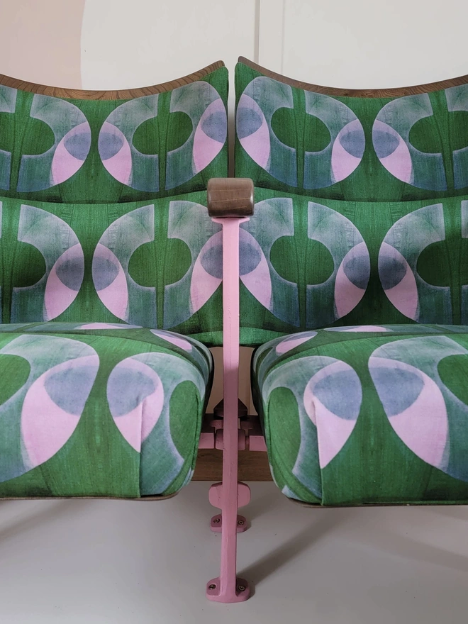Pink painted cast iron legs on vintage cinema seats in green and pink velvet
