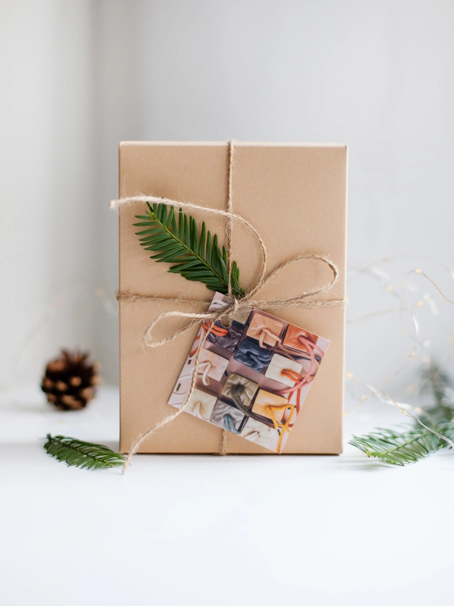 recycled card gift box wrapped with natural twine and decorated with pine needles