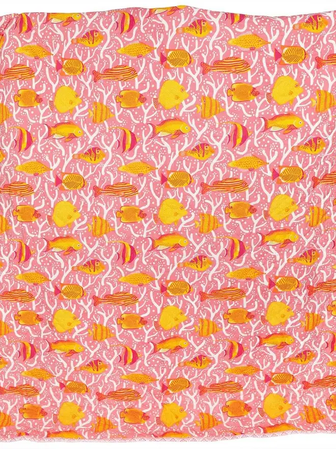 Pink Coral Reef Quilt, a pink quilt sitting on a white surface. 