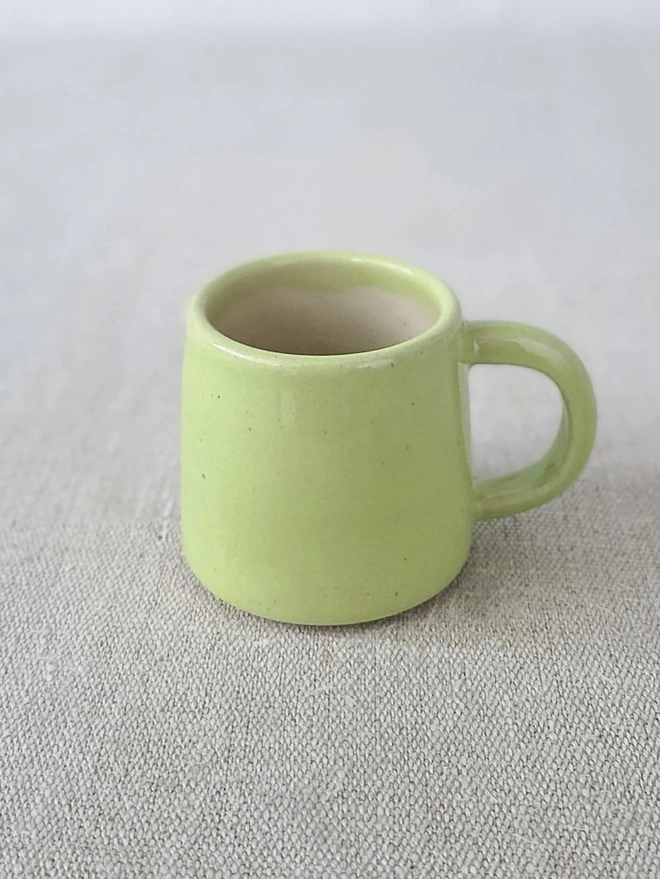 Classic Ceramic Espresso Mug, a colourful ceramic espresso mug sitting on a plain surface against a white backdrop. 