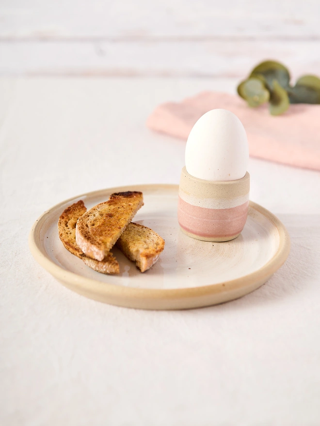 pink egg cup white plate