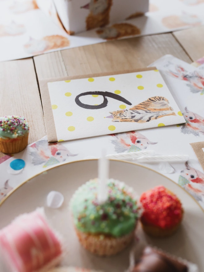 A Close up of the Tiger 9th Birthday Card on a Party themed table of Cakes 