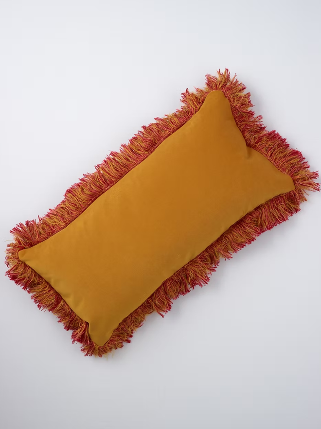 lobster tassled rectangular cushion. the back of a rectangular cushion photographed on a plain background.