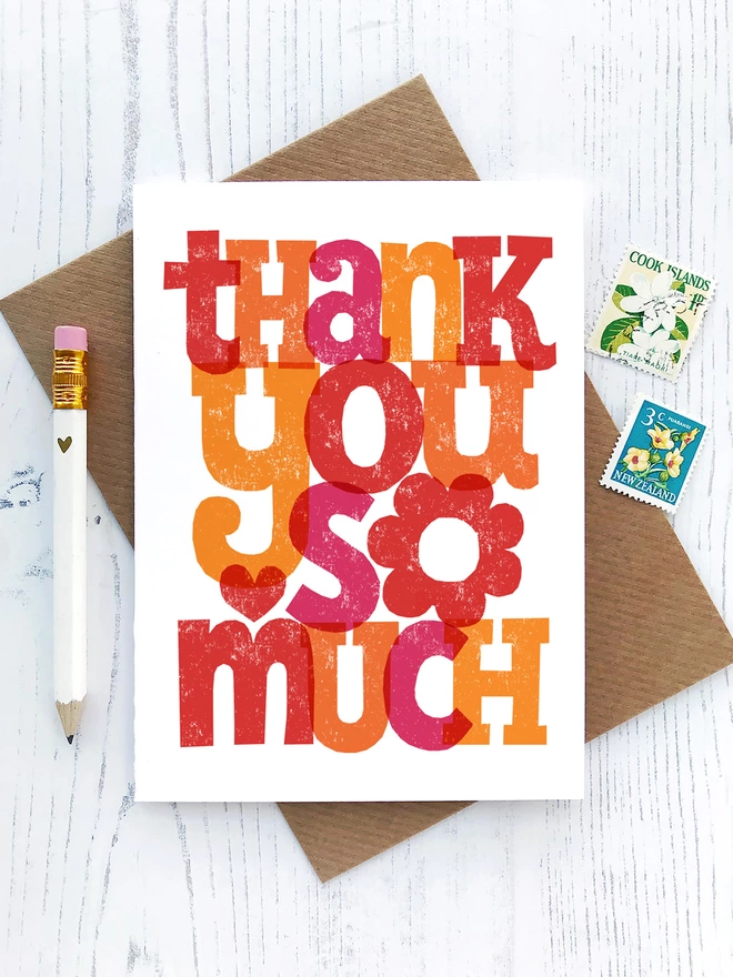 hand lettered thank you card with white pencil and stamps